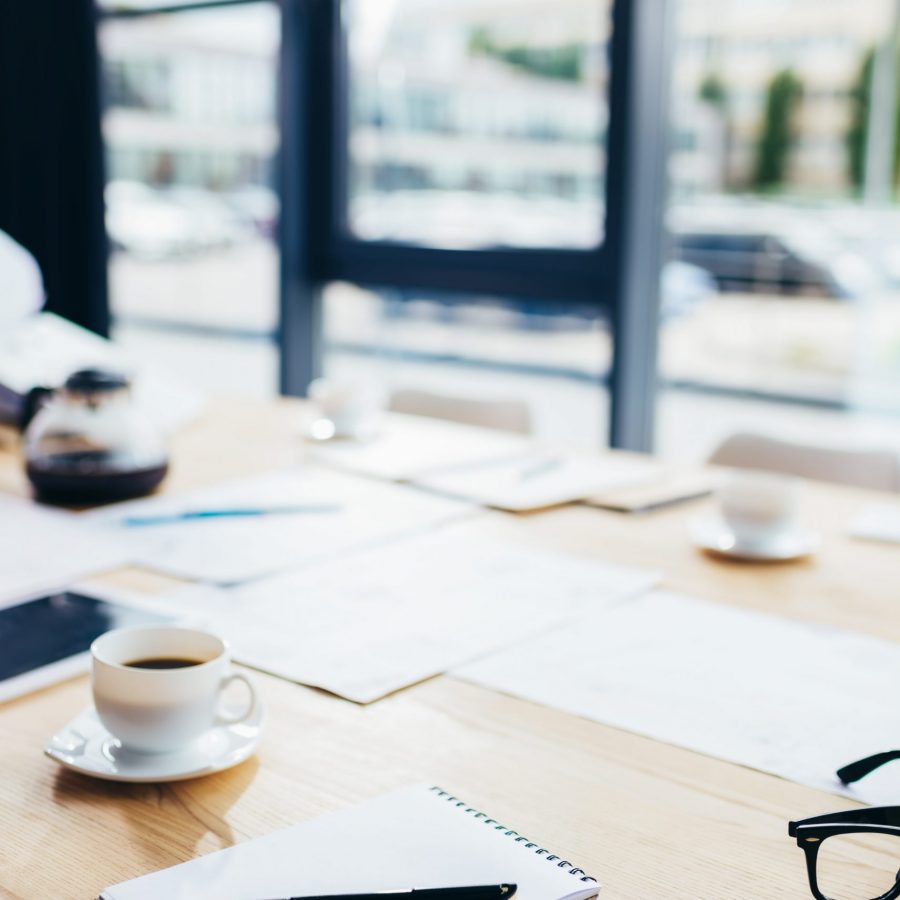 close-up view of blank notebook with pen, digital tablet and coffee on table in office